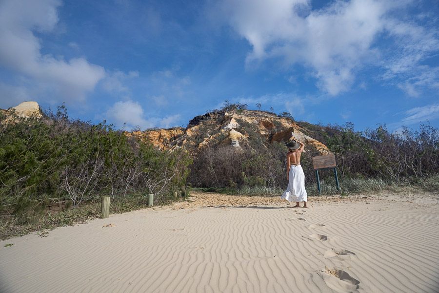 girl walking near sand dunes