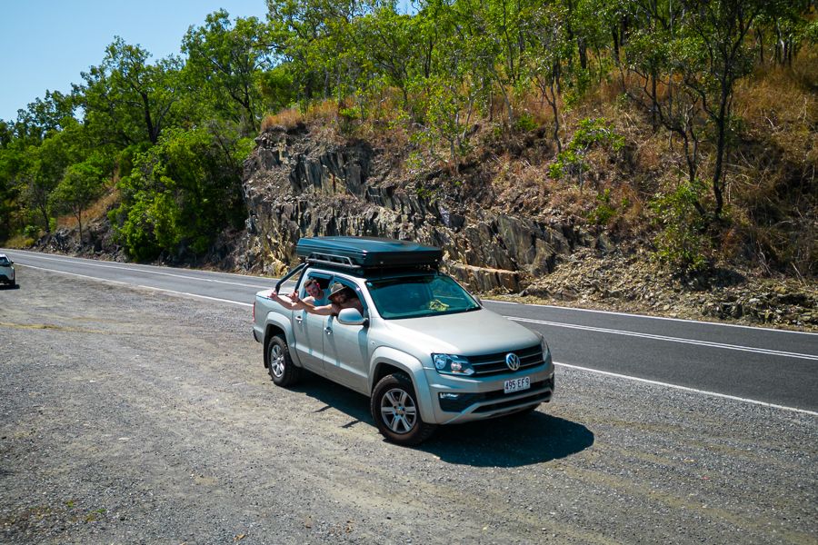 Silver 4WD car with forest in the backpground