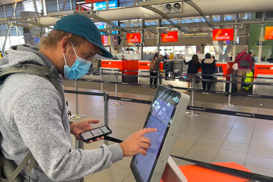 Man checking in at the self-serve counter in Sydney