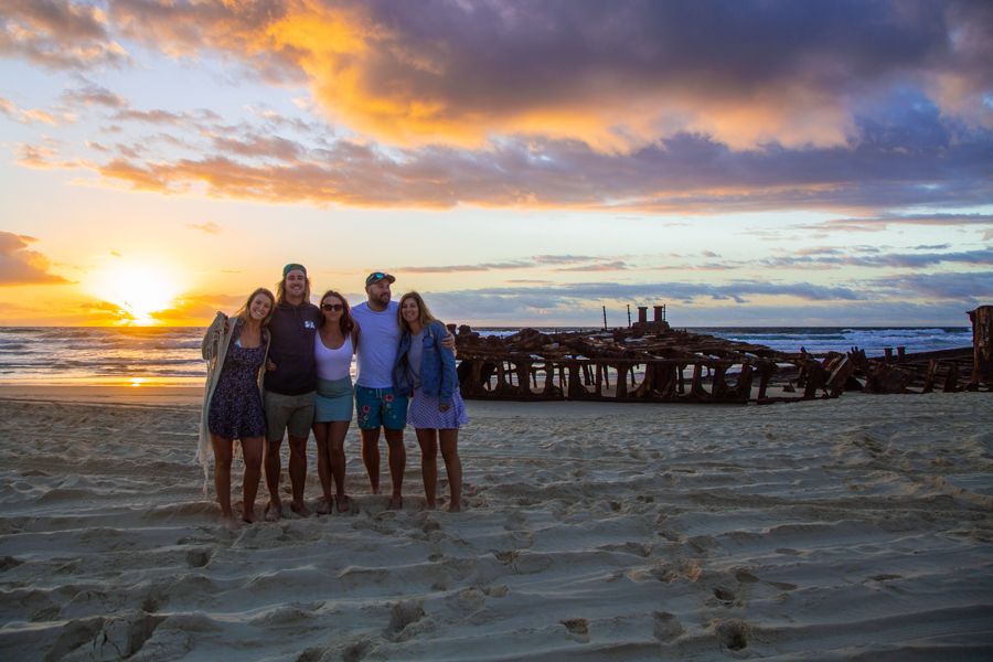 people posing at sunrise