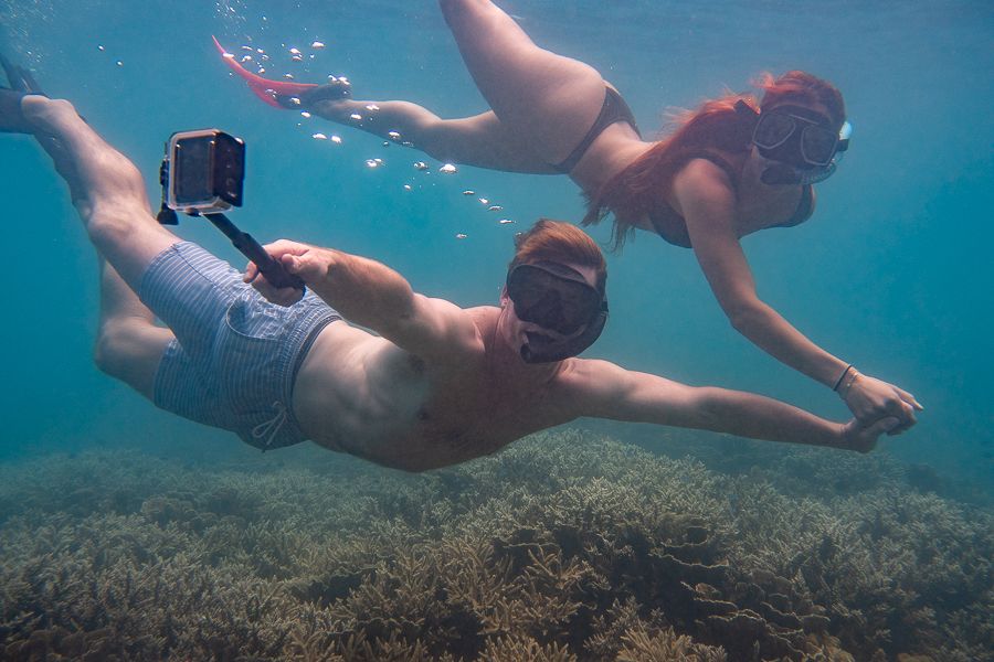 Couple snorkelling and holding hands