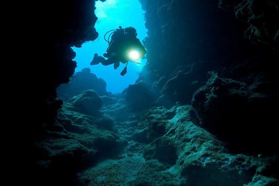 Night diving through underwater cave