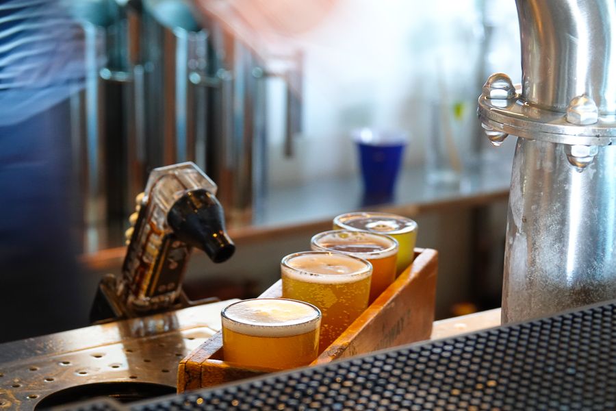 A row of beers lined up at a bar