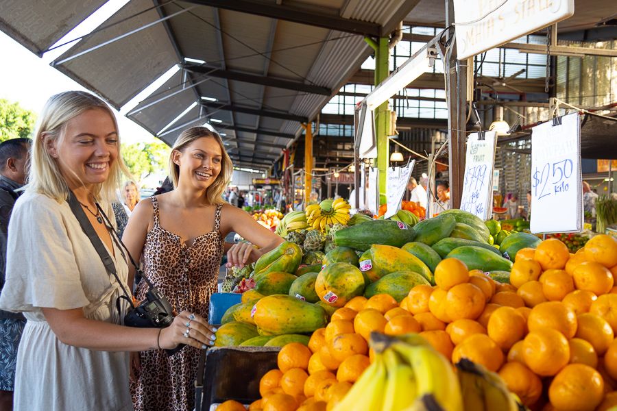 Girls shopping for fruit at rustys market in cairns