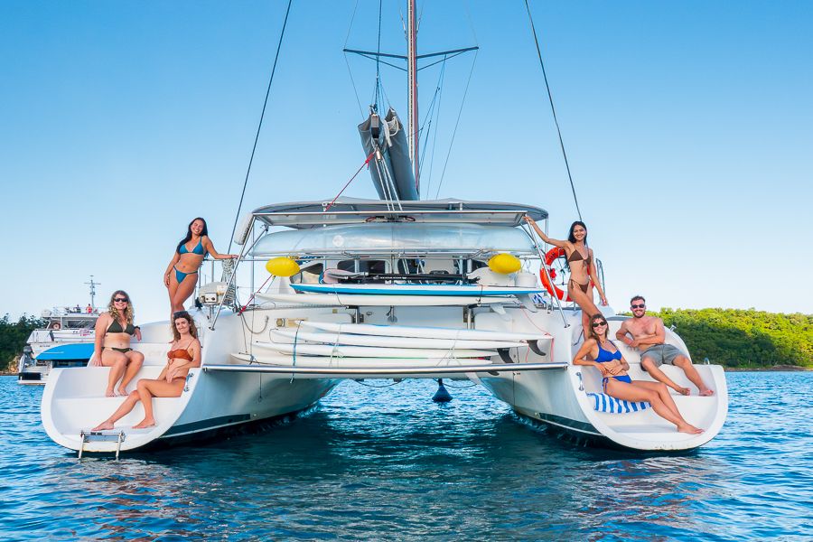 Powerplay Whitsunday Tour travellers posing on a catamaran overnight whitsunday tours