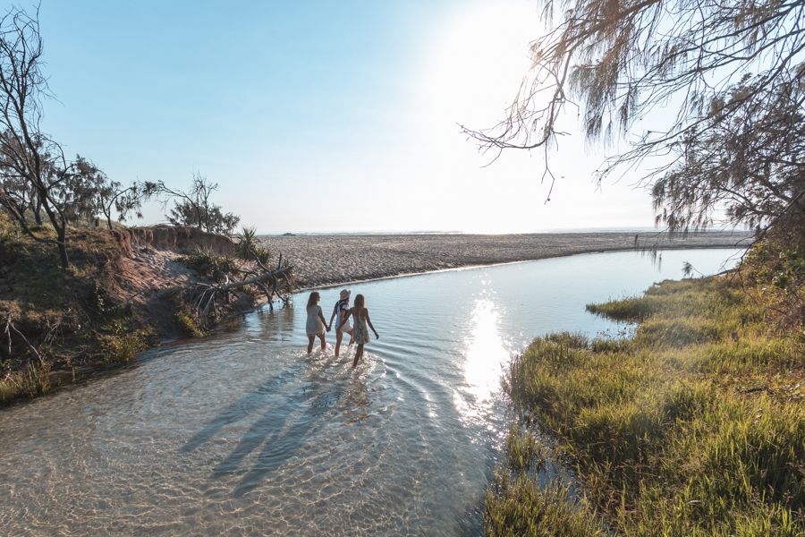 girls walking down river