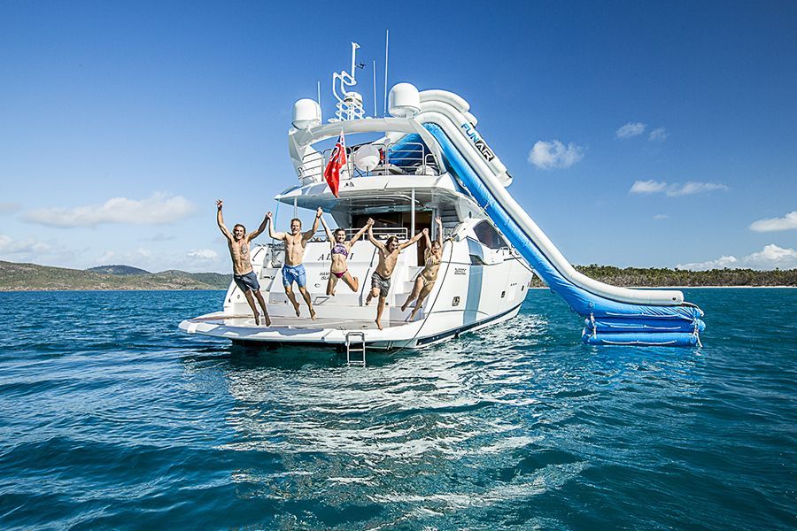 people jumping off Alani Superyacht into the water