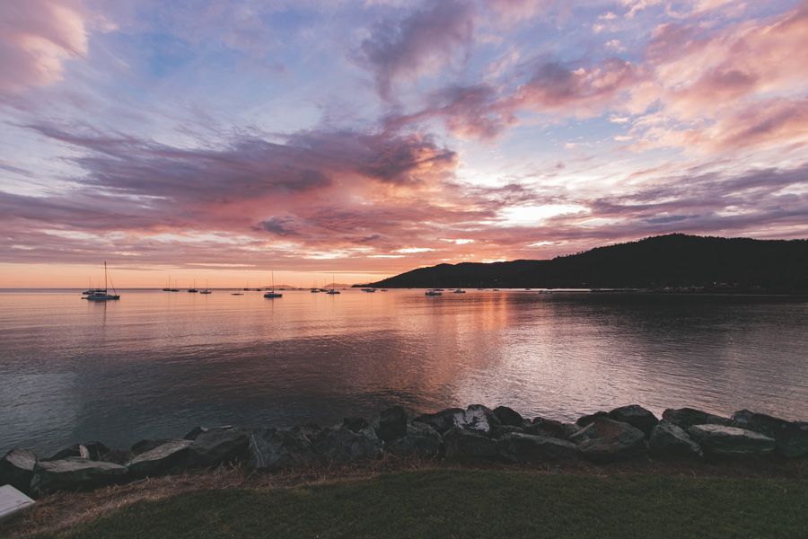 Pink sunrise over the water in airlie beach