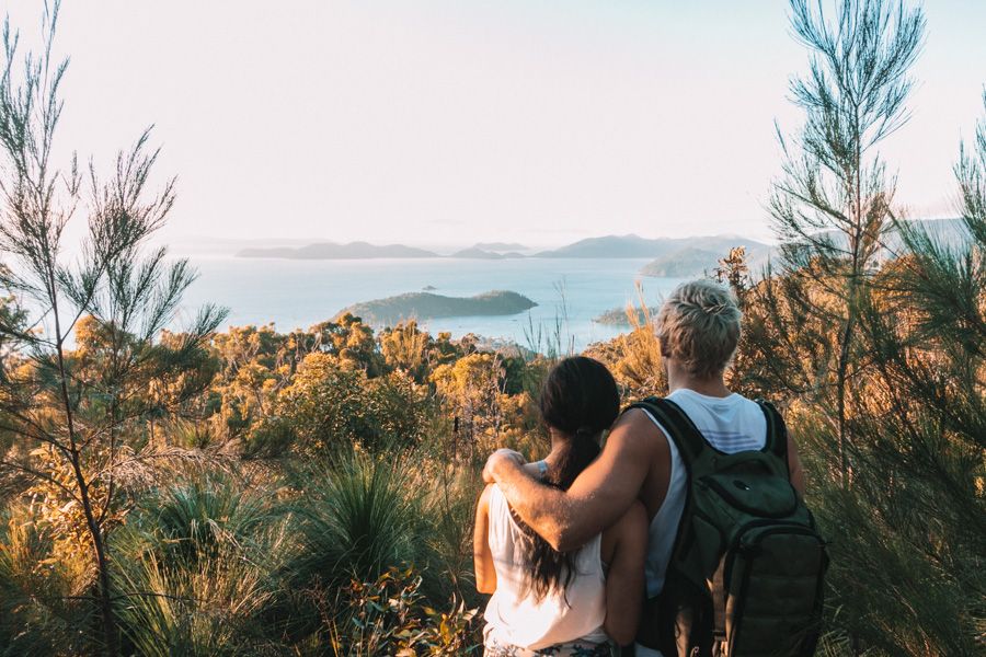 couple at a lookout while hiking in the Whitsundays