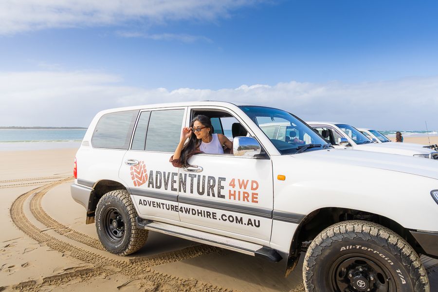girl posing out the window of a 4wd hire vehicle kgari