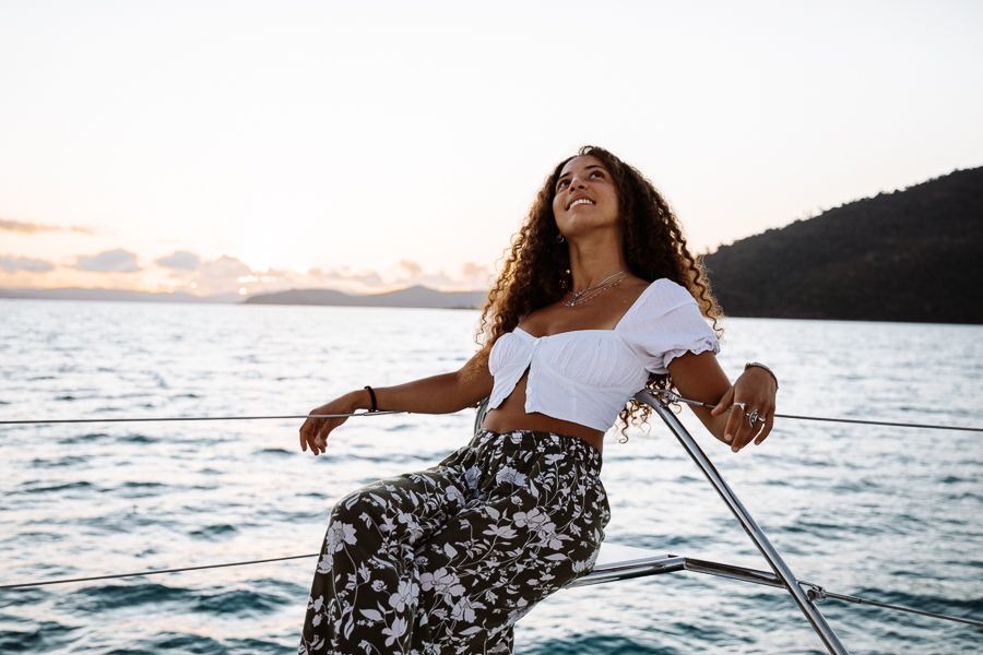 A woman relaxing on a boat in the Whitsundays