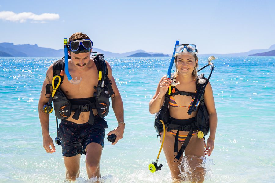 Couple scuba diving from the beach