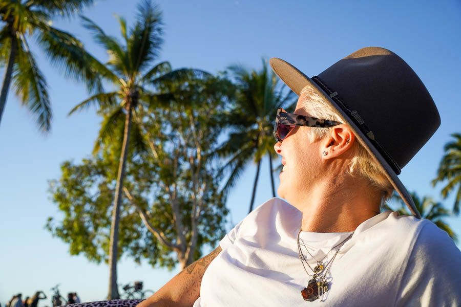 Woman in festival hat looking off into distance 