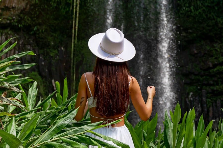 Girl in festival outfit surrounded by greenery