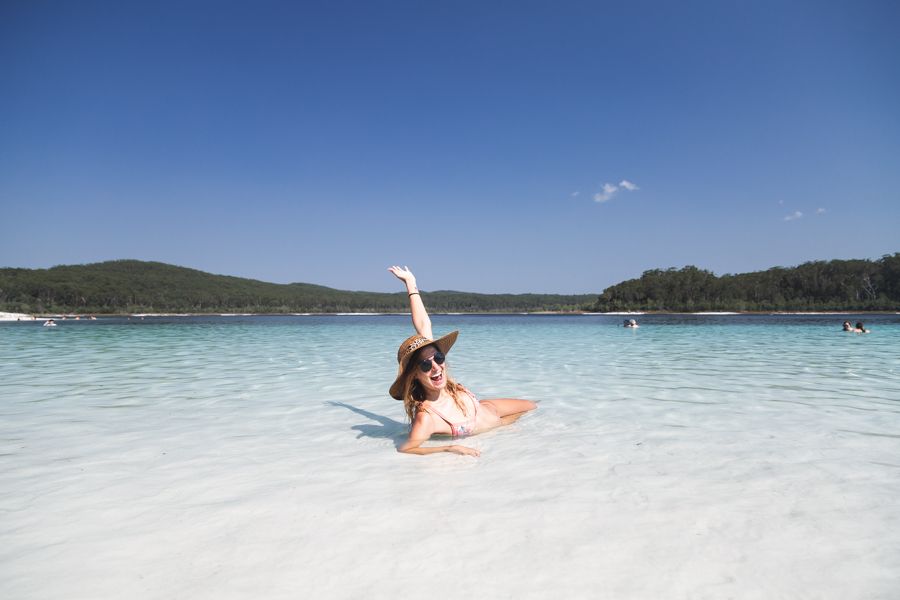 person lounging in the sand on Lake Mckenzie