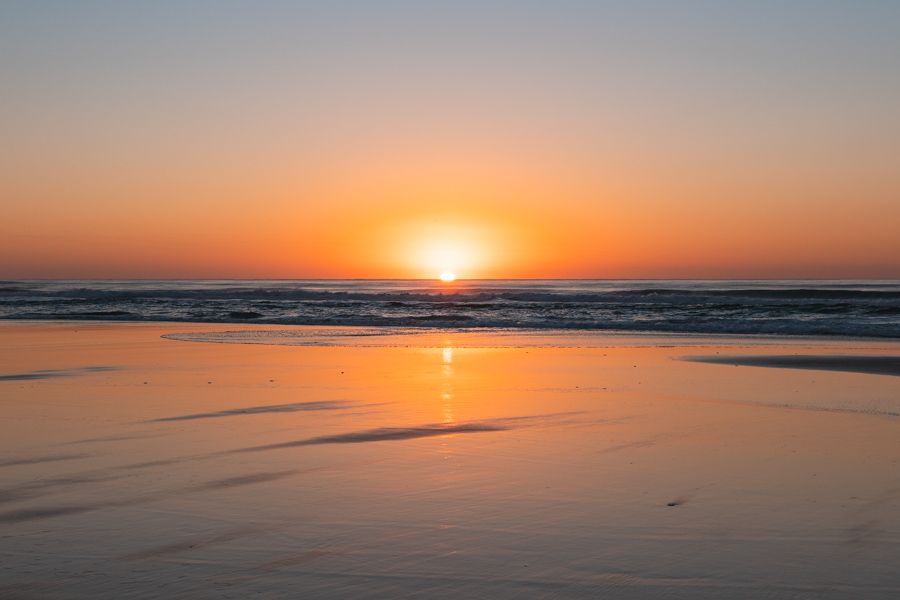 sun setting over the ocean by the shores of K'gari