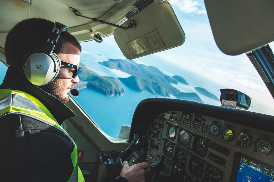 Pilot flying seaplane over Whitsundays