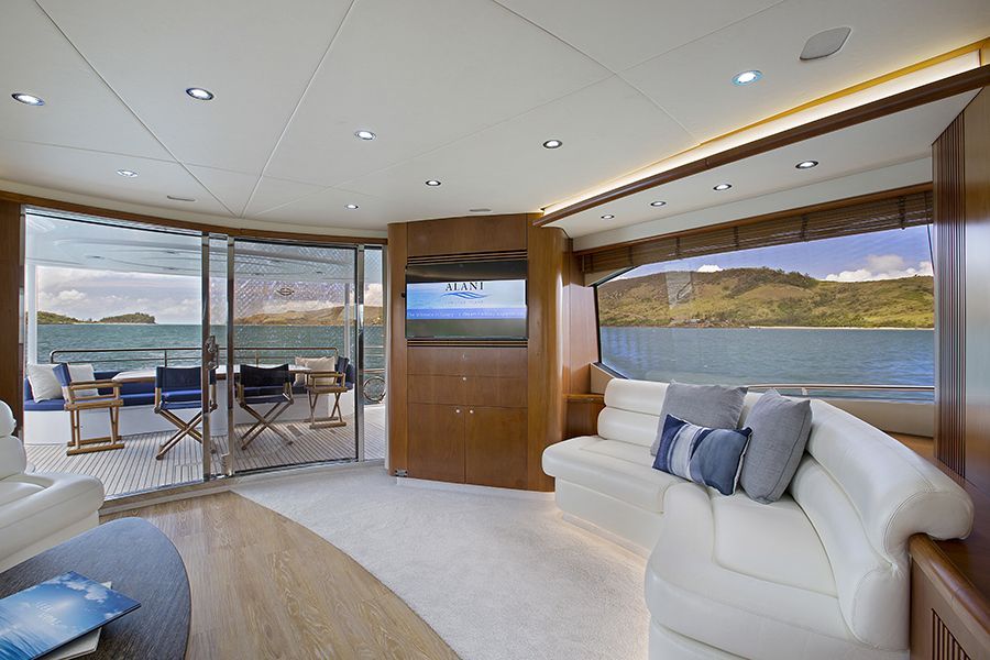 The interior of a superyacht with green islands and ocean in the background