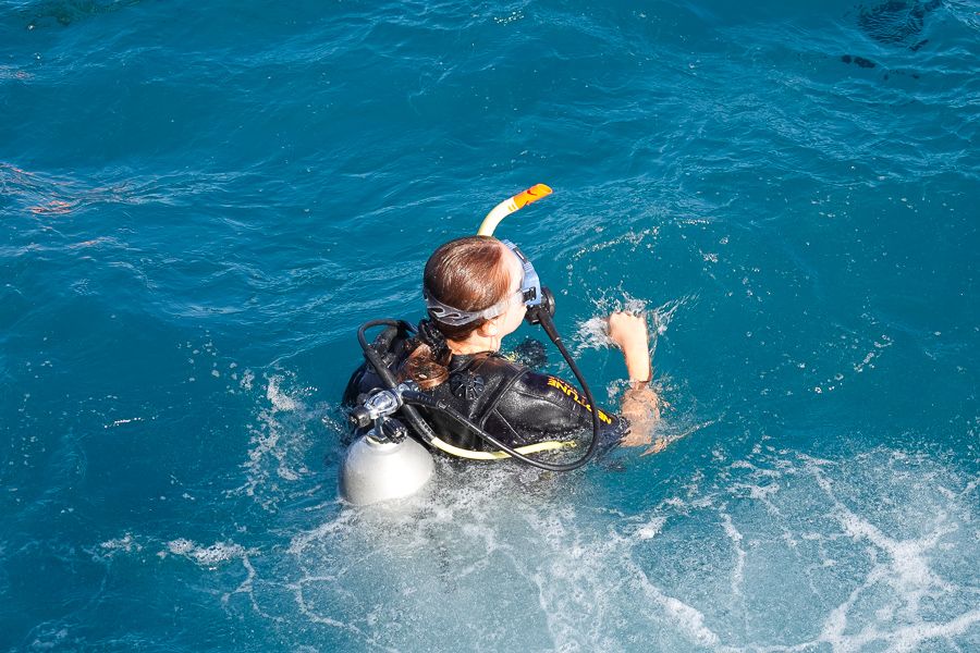 Diver floating on surface of water