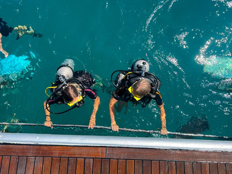 Two divers prepare to submerge