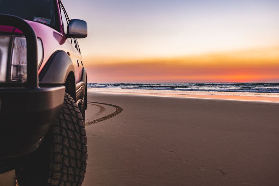 car parked on the beach of K'gari (Fraser Island) at sunrise