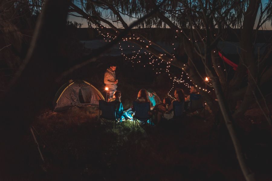 nighttime campsite with fairy lights in the forest on K'gari