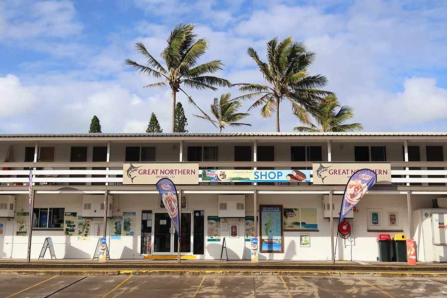 Eurong Resort General Store with blue skies and palm trees on K'gari