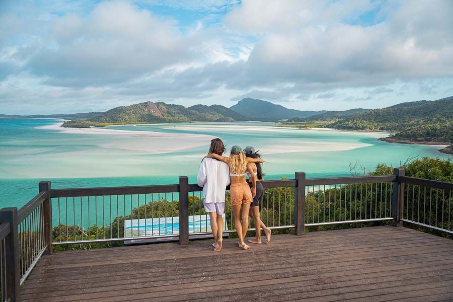 travellers admiring hill inlet lookout at Whitehaven Beach