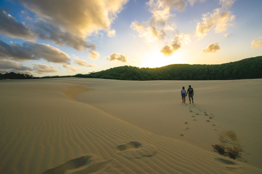 couple walking on the sand dunes at Lake Wabby