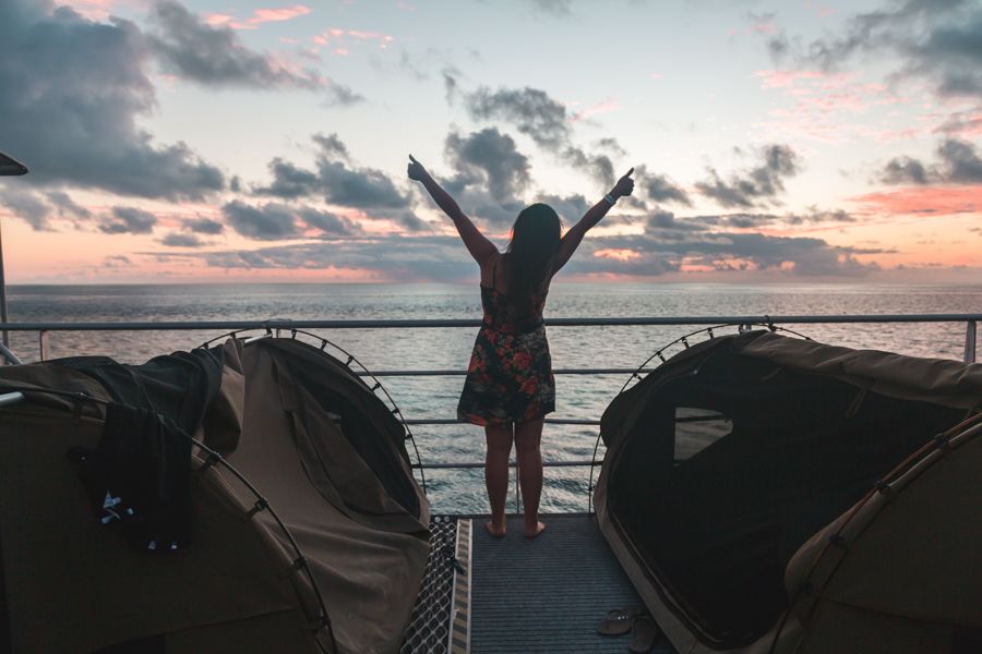 Girl posing next to reef beds on Reefsleep at sunset