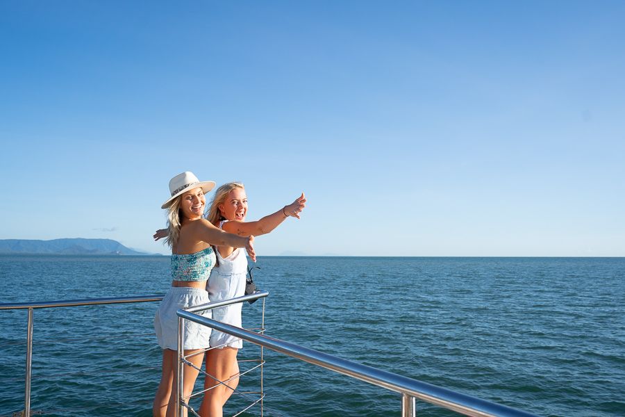 girls posing on the front of a boat on the great barrier reef