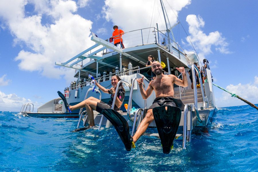 snorkellers smiling on a Great Barrier Reef tour from cairns