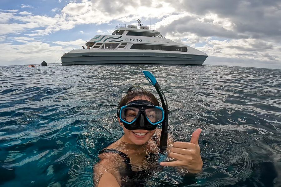 snorkeller smiling on tusa reef tours boat trip from cairns