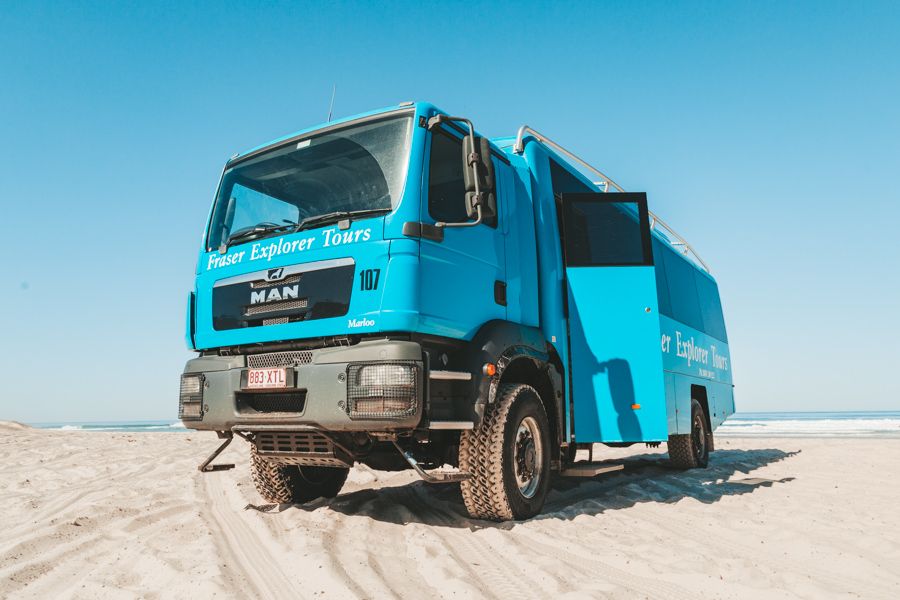 Fraser Explorer Tours blue 4wd bus on the beach