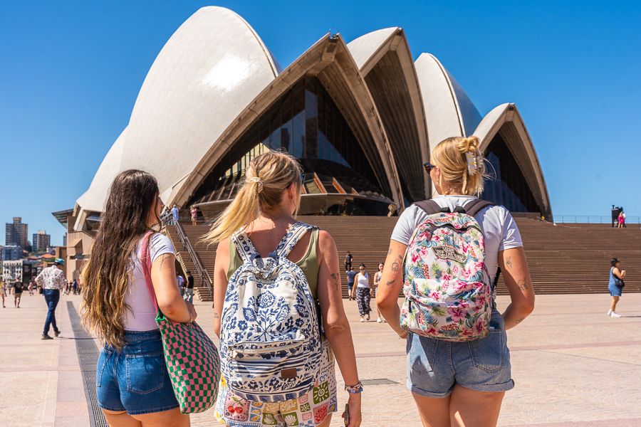 three girls with backpacks near sydney opera house australia