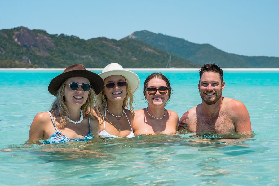 A group of friends in the Whitsunday ISlands swimming