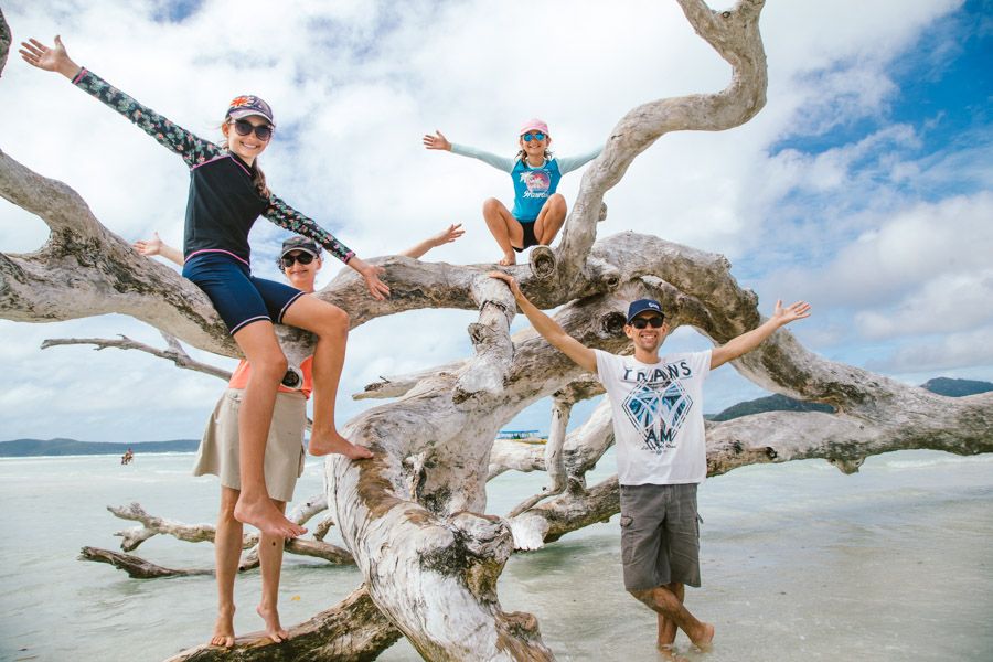 group posing with driftwood Whitehaven Beach