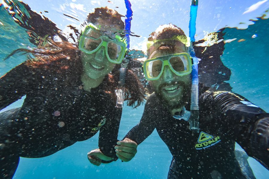 Two people snorkelling in water