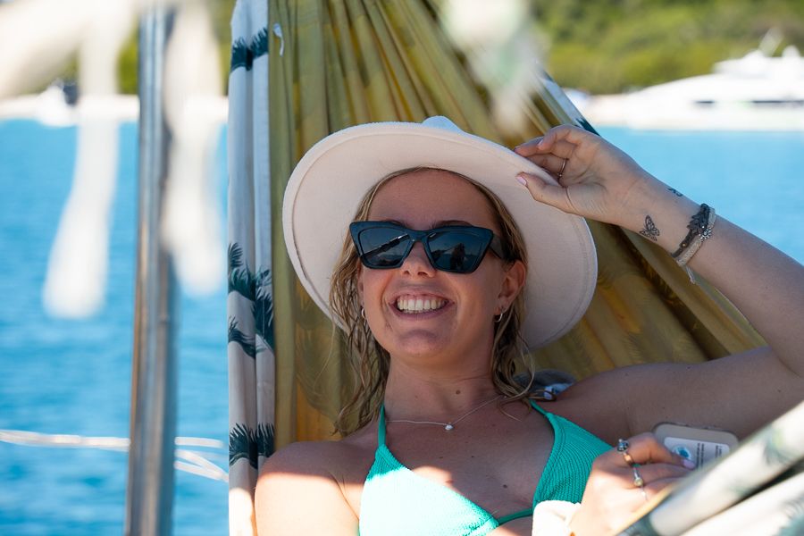 A woman in a wide brim hat in a hammock