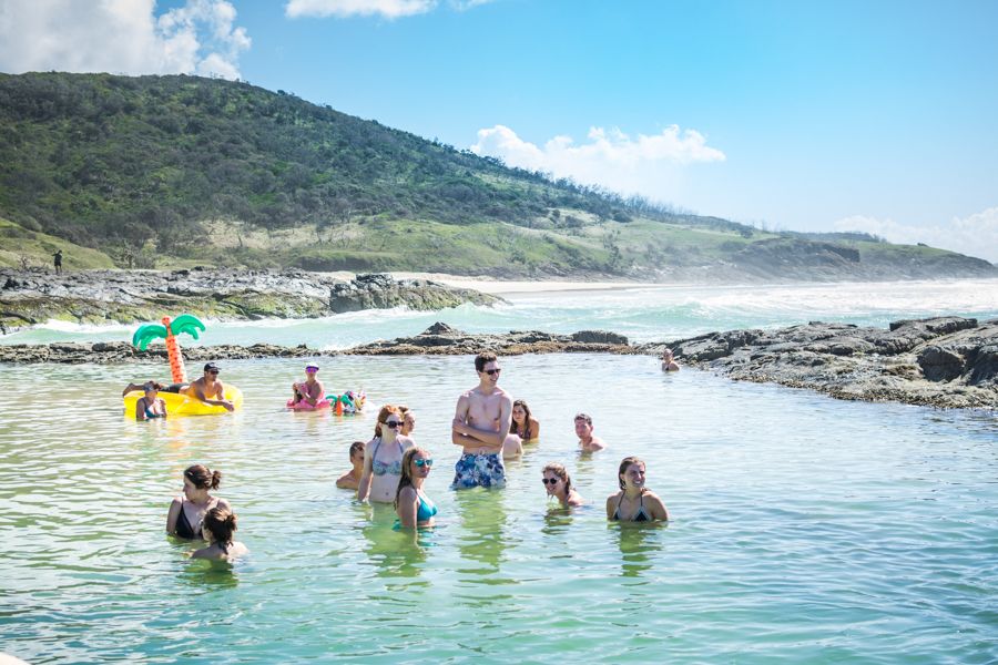 people floating in the champagne pools on K'gari