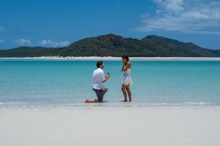 couple getting engaged on whitehaven beach whitsundays