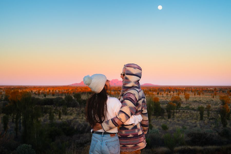 couple posing in front of sunrise in australia outback