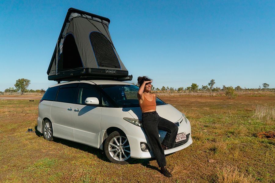 girl leaning against a van in the australian outback