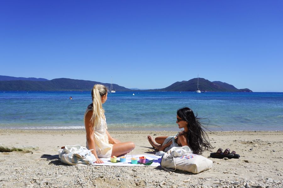 Two girls relaxing on the beach on Fitzroy Island