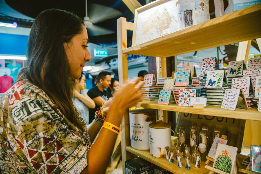 girl browsing local goods at an indoor market hall