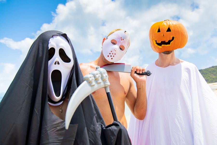 Halloween in the Whitsundays 2025 three men in masks dressed up for halloween on a beach