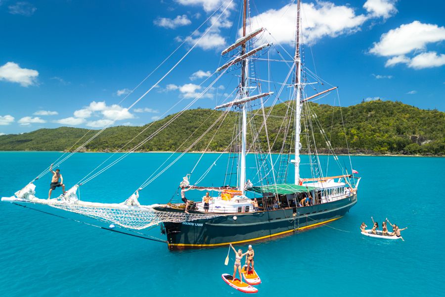 A drone shot of a sailing yacht