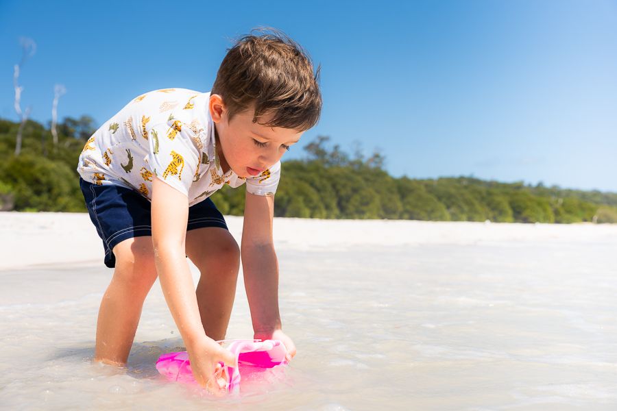 A child building a sandcastle on the beach