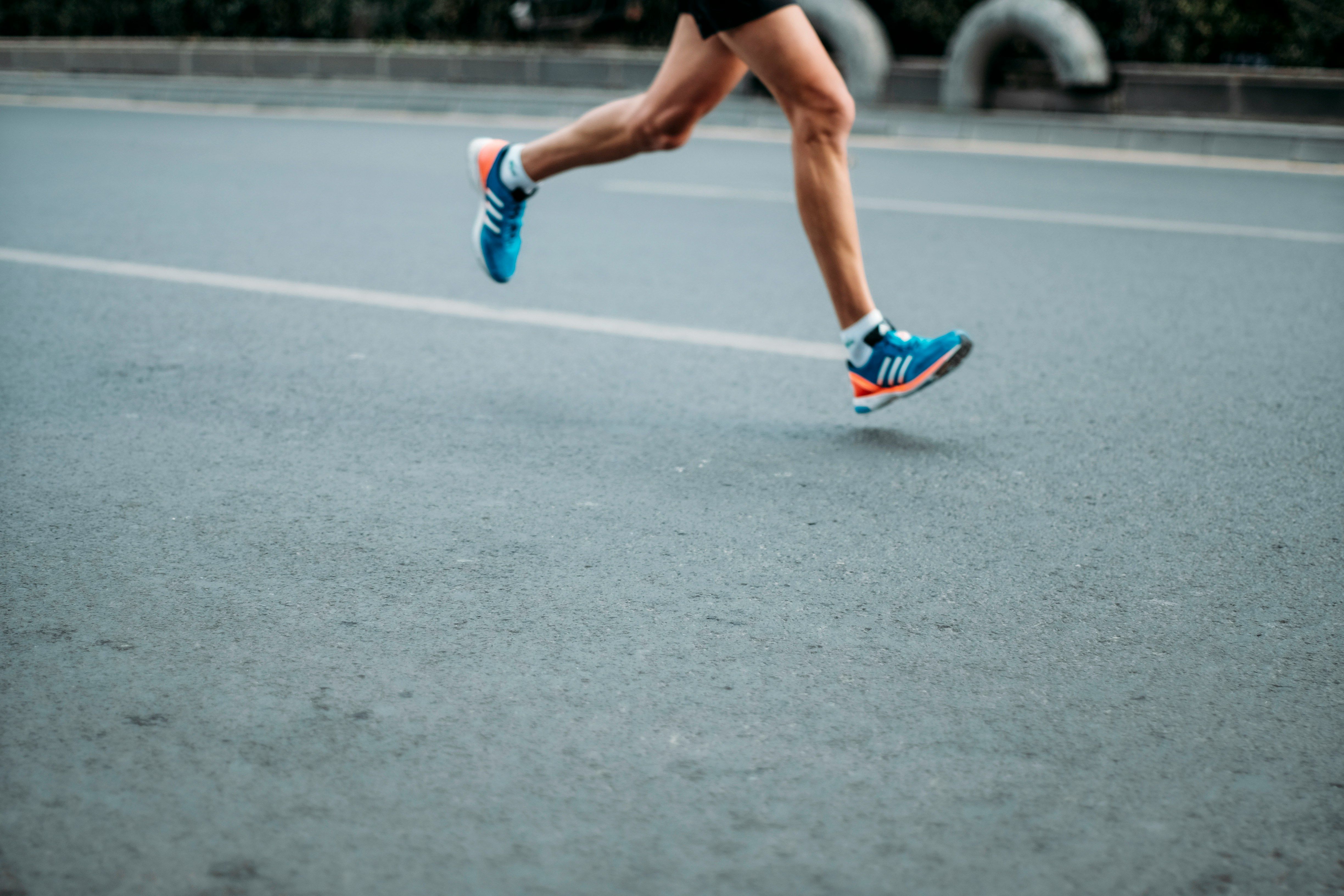 runner running along a concrete road