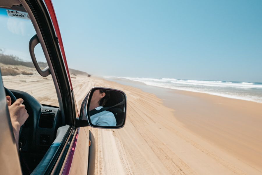 4WD car driving along the sand on K'gari (Fraser Island)
